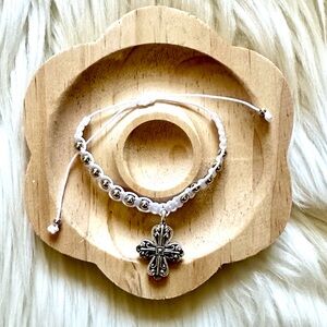 Handmade White String with Cross Adjustable Bracelet
Silver tone